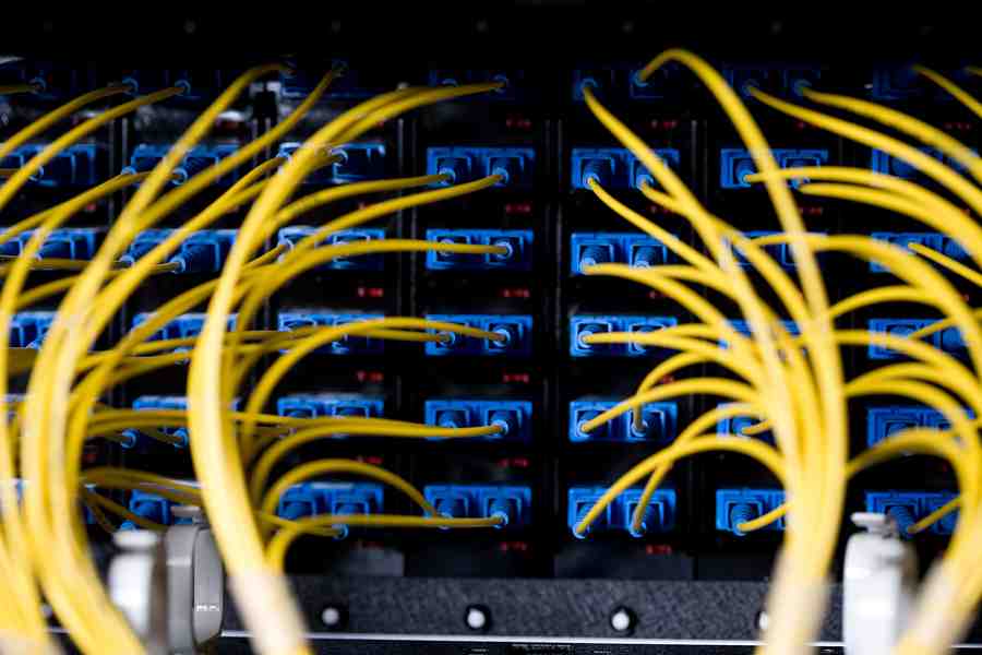 Professional technician testing a network port in a commercial office environment