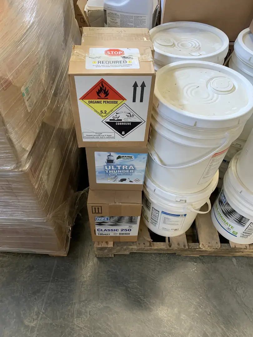 A person correctly applying a hazard label to a UN-certified box - dangerous goods shipping A person correctly applying a hazard label to a UN-certified box - dangerous goods shipping