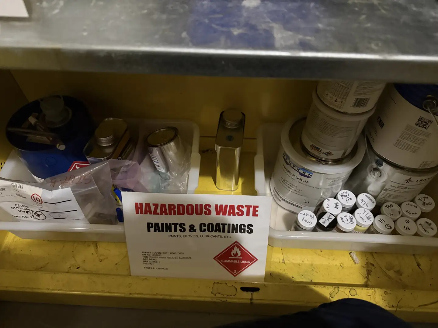 Properly labeled hazardous waste drums in secondary containment Properly labeled hazardous waste drums in secondary containment