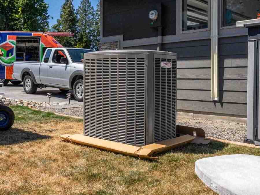 outdoor heat pump unit next to a house - home heating solutions outdoor heat pump unit next to a house - home heating solutions