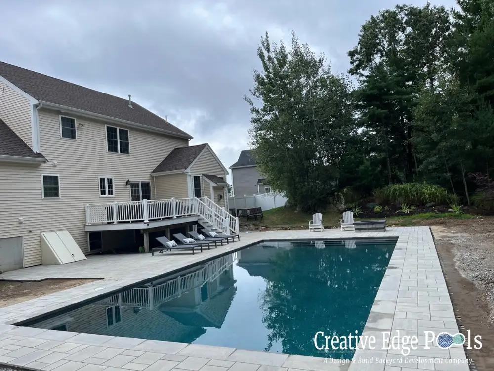 modern rectangular pool design in a beautifully landscaped backyard