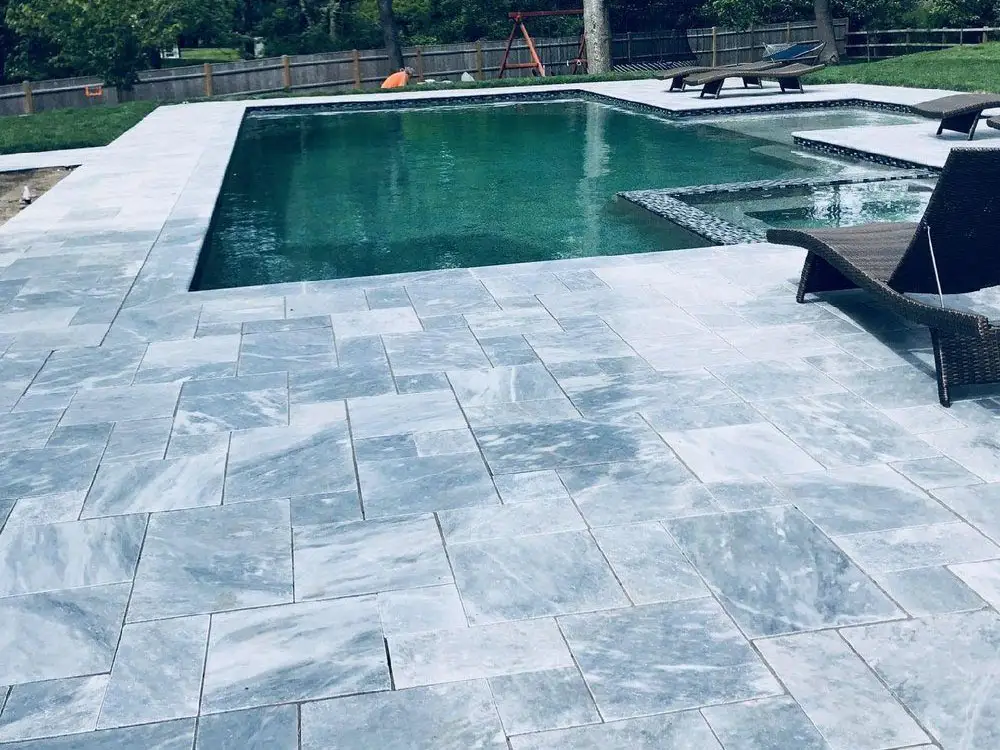 Modern patio space with stone pavers and comfortable seating - Outdoor living financing