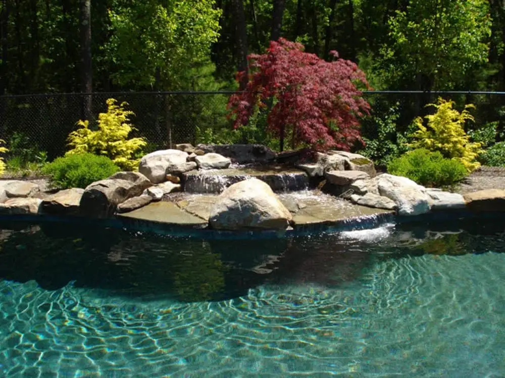 Small pool with a custom waterfall and lighting