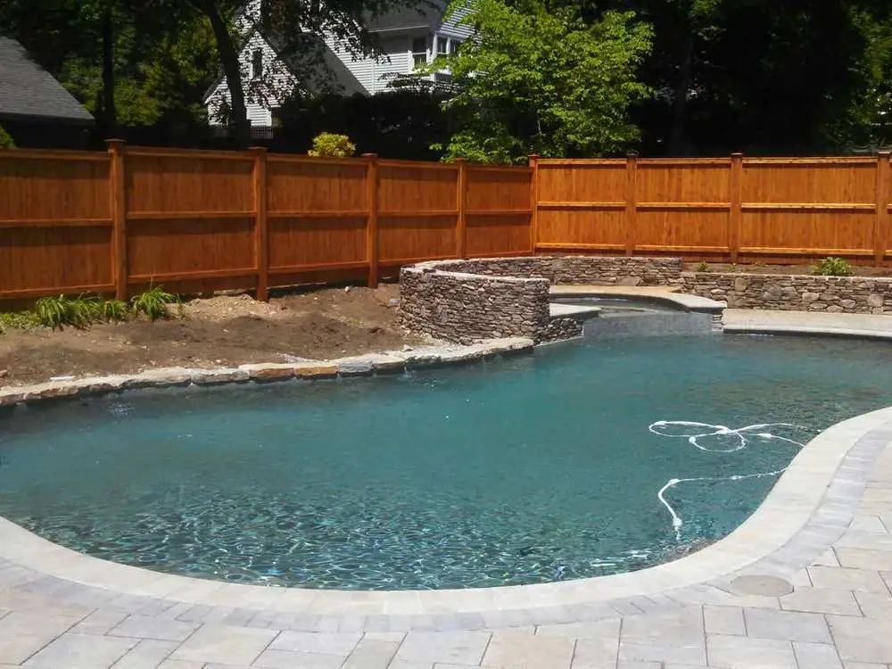 custom masonry and retaining wall surrounding an above ground pool