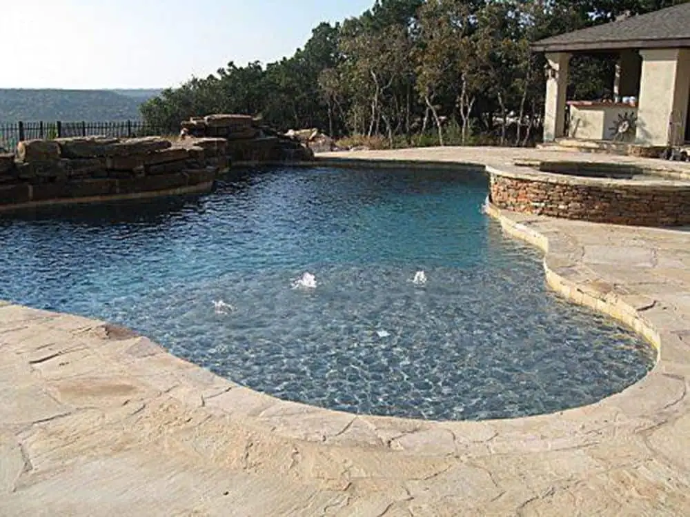 well-maintained stone pool deck