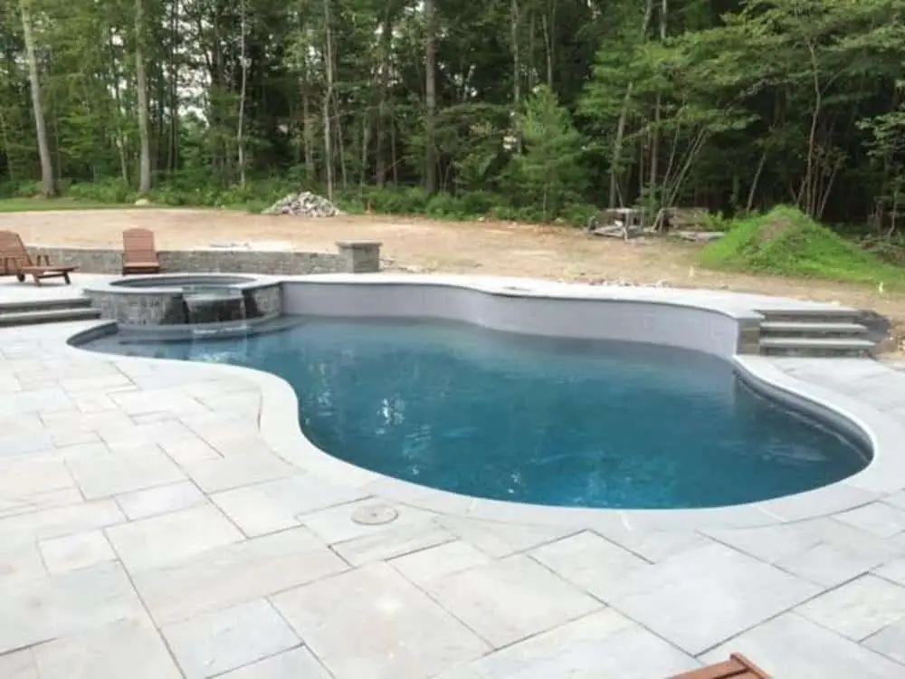 custom gunite pool with integrated spa and stone waterfall - Pool and spa installation