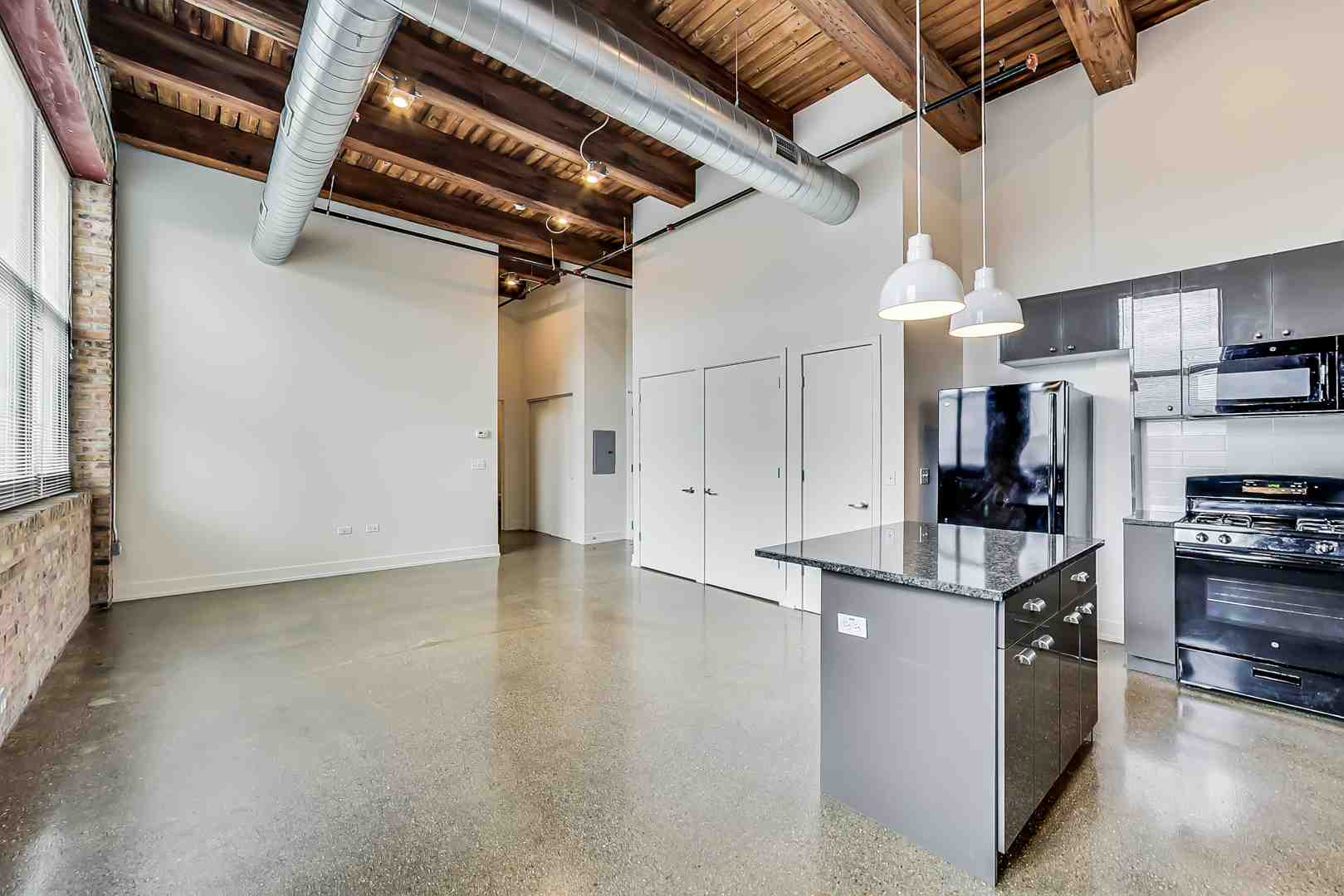 modern furnished kitchen with stainless steel appliances and quartz countertops - furnished apartments lincoln park chicago