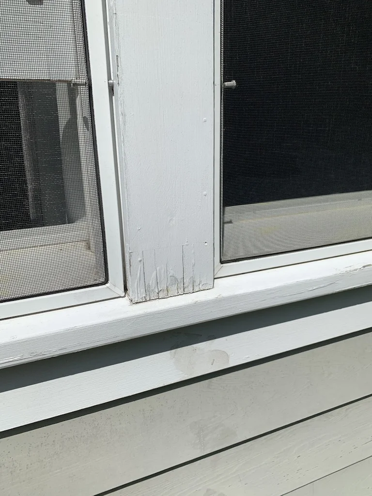 painter performing meticulous surface scraping - exterior painting Lexington Massachusetts