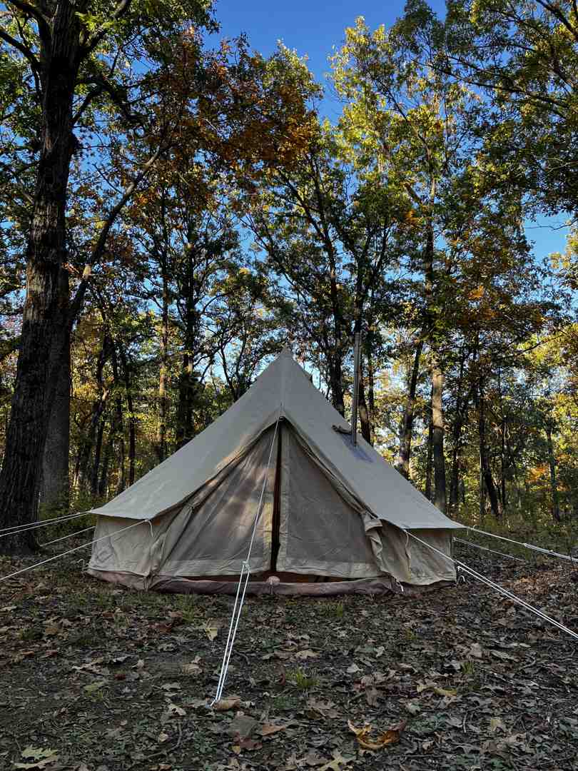 two different styles of portable wood burners suitable for tents, one cast iron and one steel - log burner for bell tent