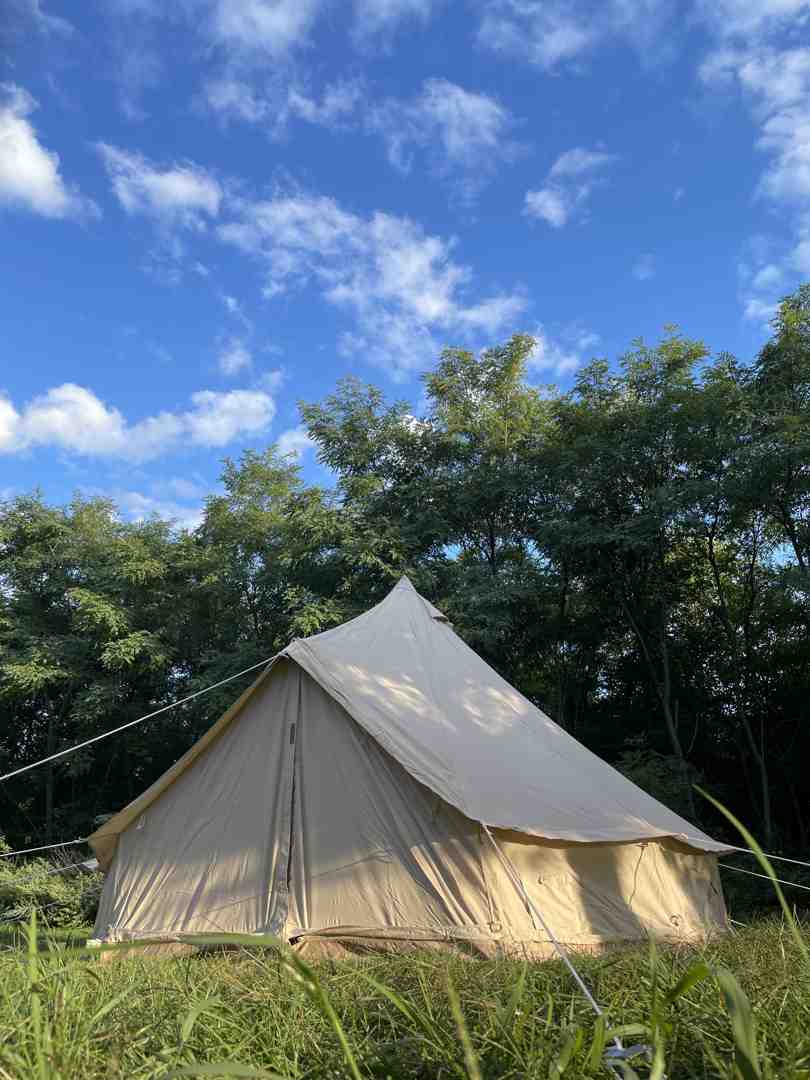 Canvas bell tent standing strong in a festival field - best canopy for festivals Canvas bell tent standing strong in a festival field - best canopy for festivals