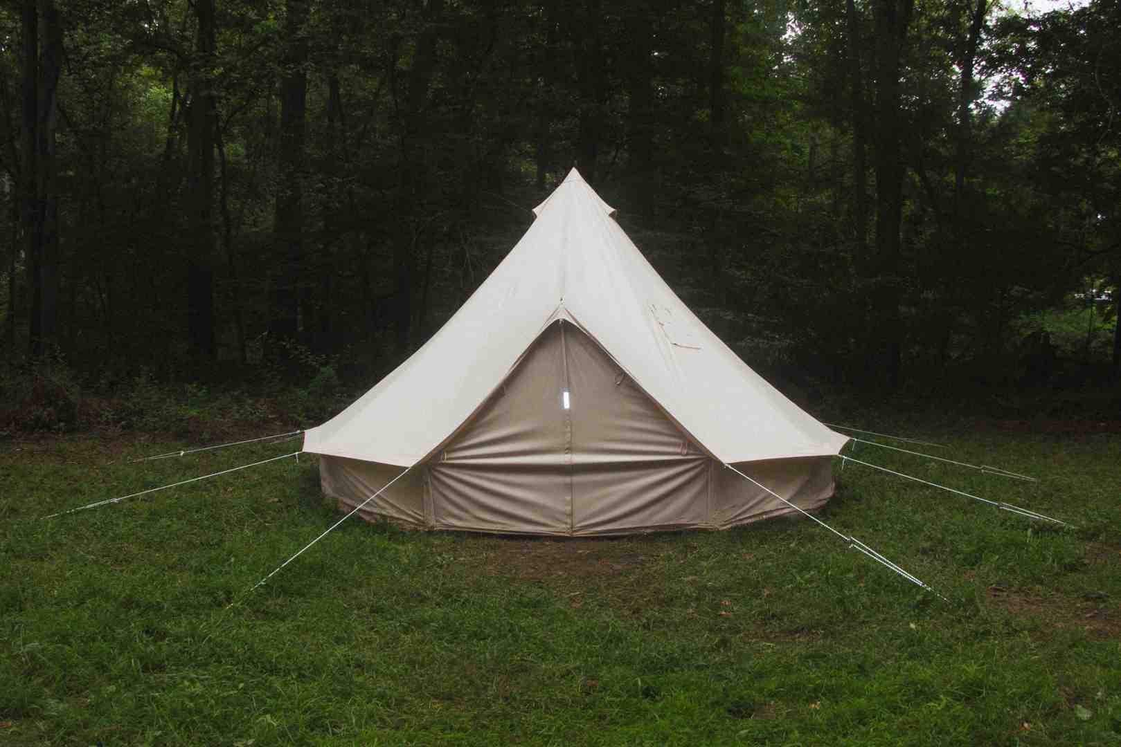 person hosing down a new Stout Bell Tent - canvas tent waterproofing