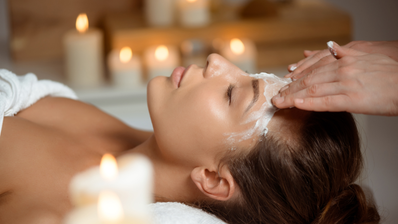 esthetician applying a customized mask to a client's back - back facial massage esthetician applying a customized mask to a client's back - back facial massage