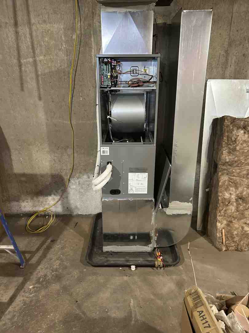 Technician mounting a humidifier on a return duct - downflow furnace humidifier