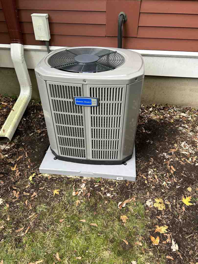 Modern outdoor air conditioning condenser unit installed on a level pad - smithfield hvac