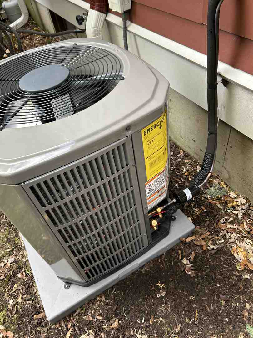 HVAC technician inspecting an outdoor AC unit with professional tools - affordable air conditioning service HVAC technician inspecting an outdoor AC unit with professional tools - affordable air conditioning service