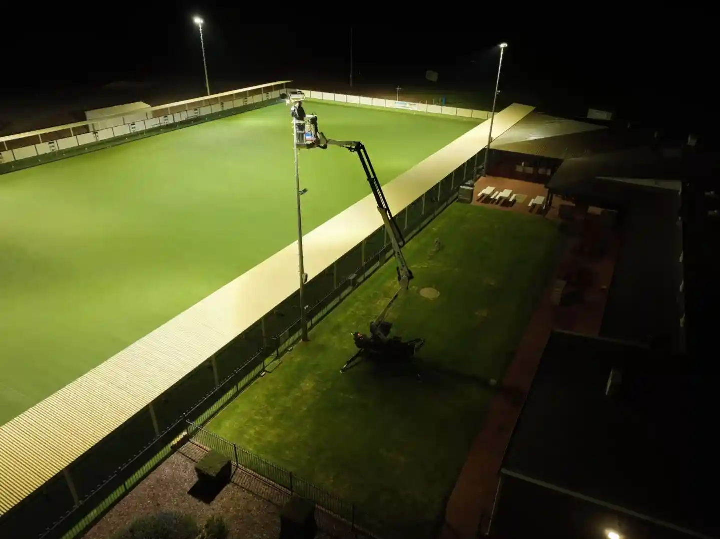 Image showing a brightly lit sports field at night, illuminated by modern LED high mast lighting, with clear visibility and minimal glare - High mast lighting