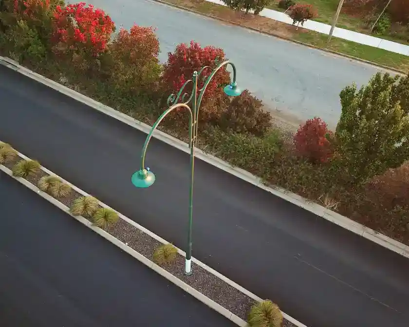 Modern LED commercial street lamps showing different styles including cobra head, shoebox, and post-top designs installed in Australian urban environments - commercial street lamps