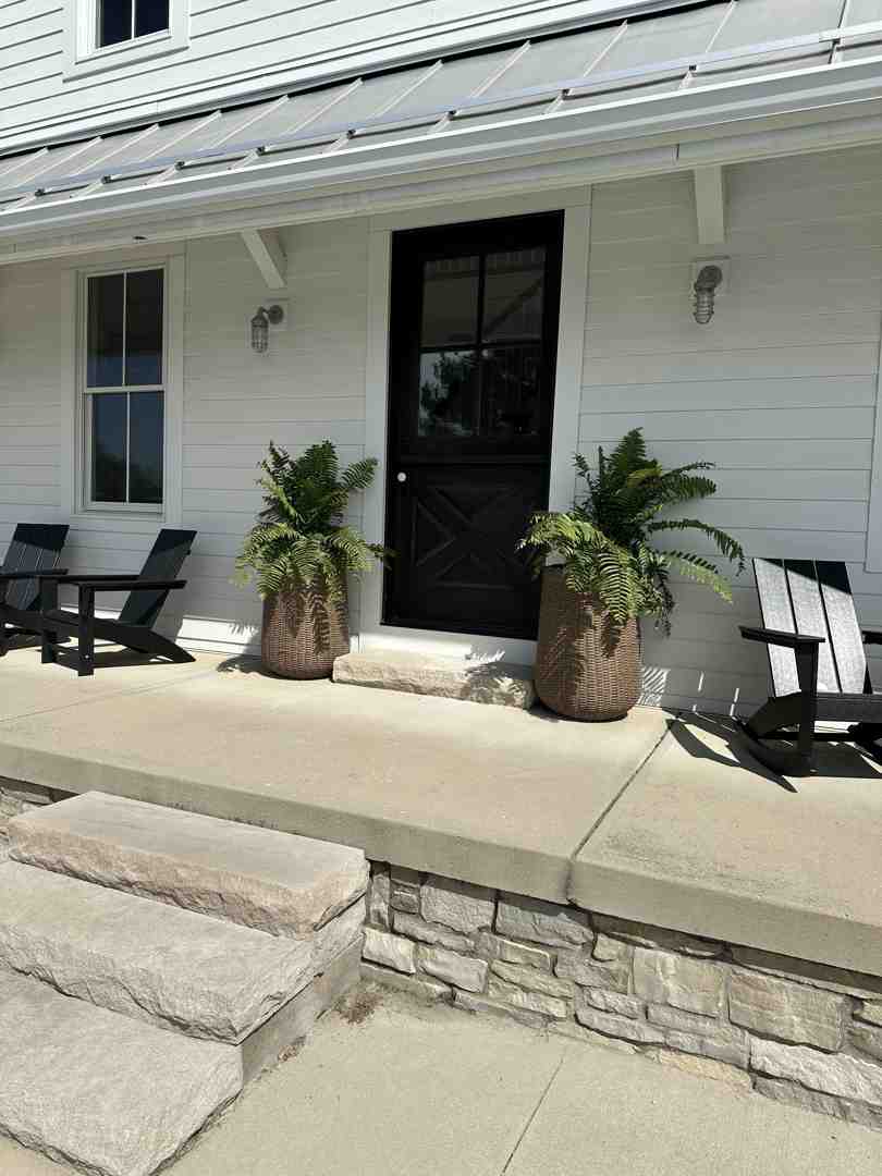 modern farmhouse with a wraparound porch - architect house designs