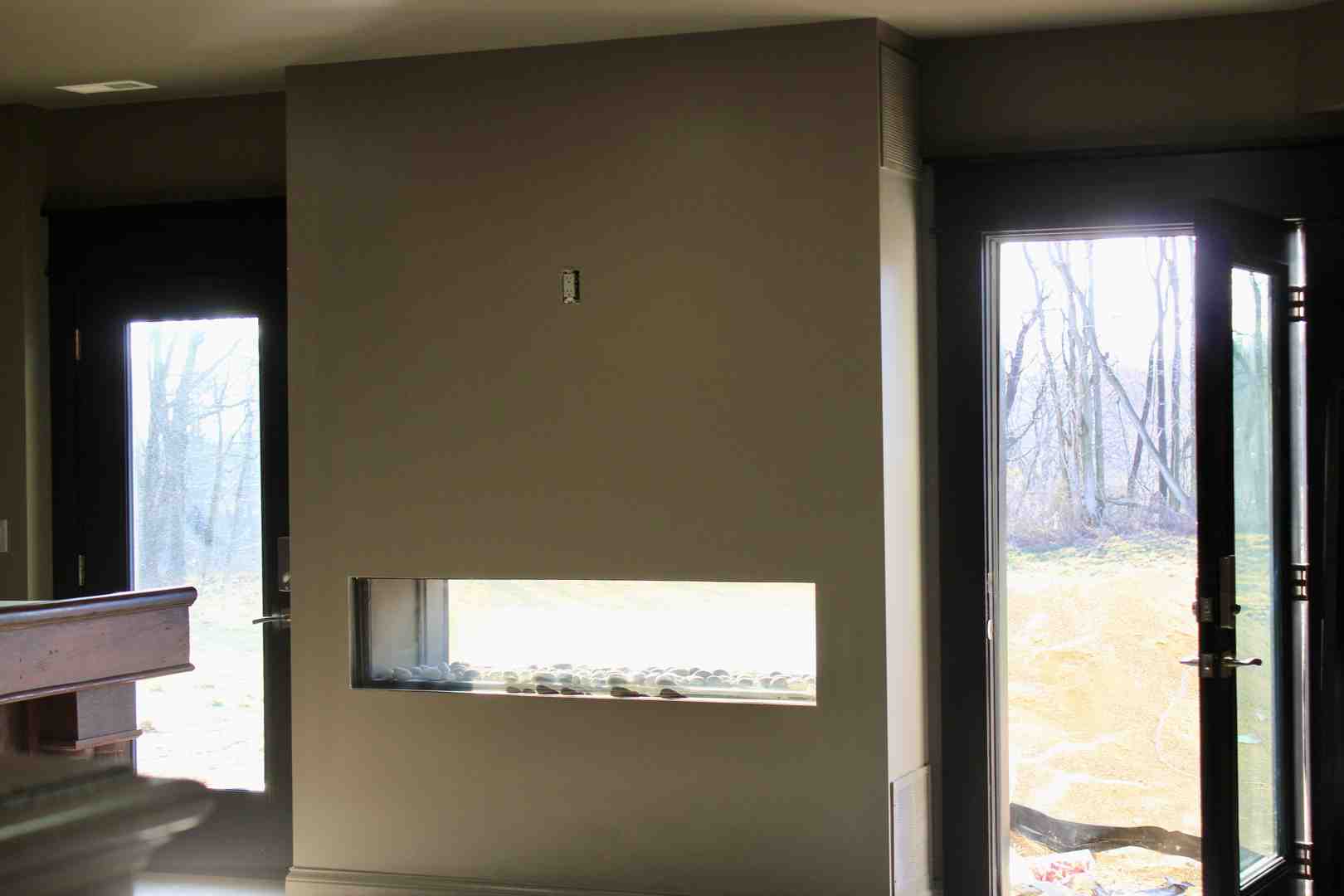 Minimalist interior featuring floor-to-ceiling glass walls overlooking natural landscape with clean lines and seamless indoor-outdoor integration - modern architecture glass