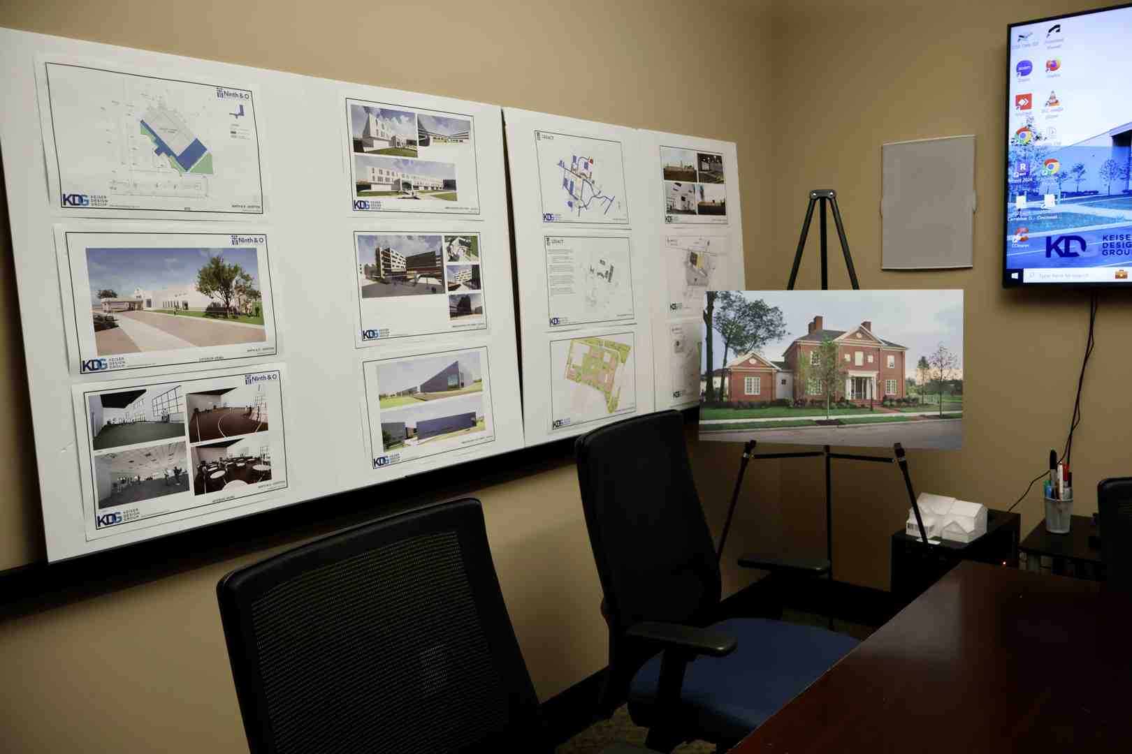 an architect and client reviewing blueprints and material samples in a design studio - residential architect services