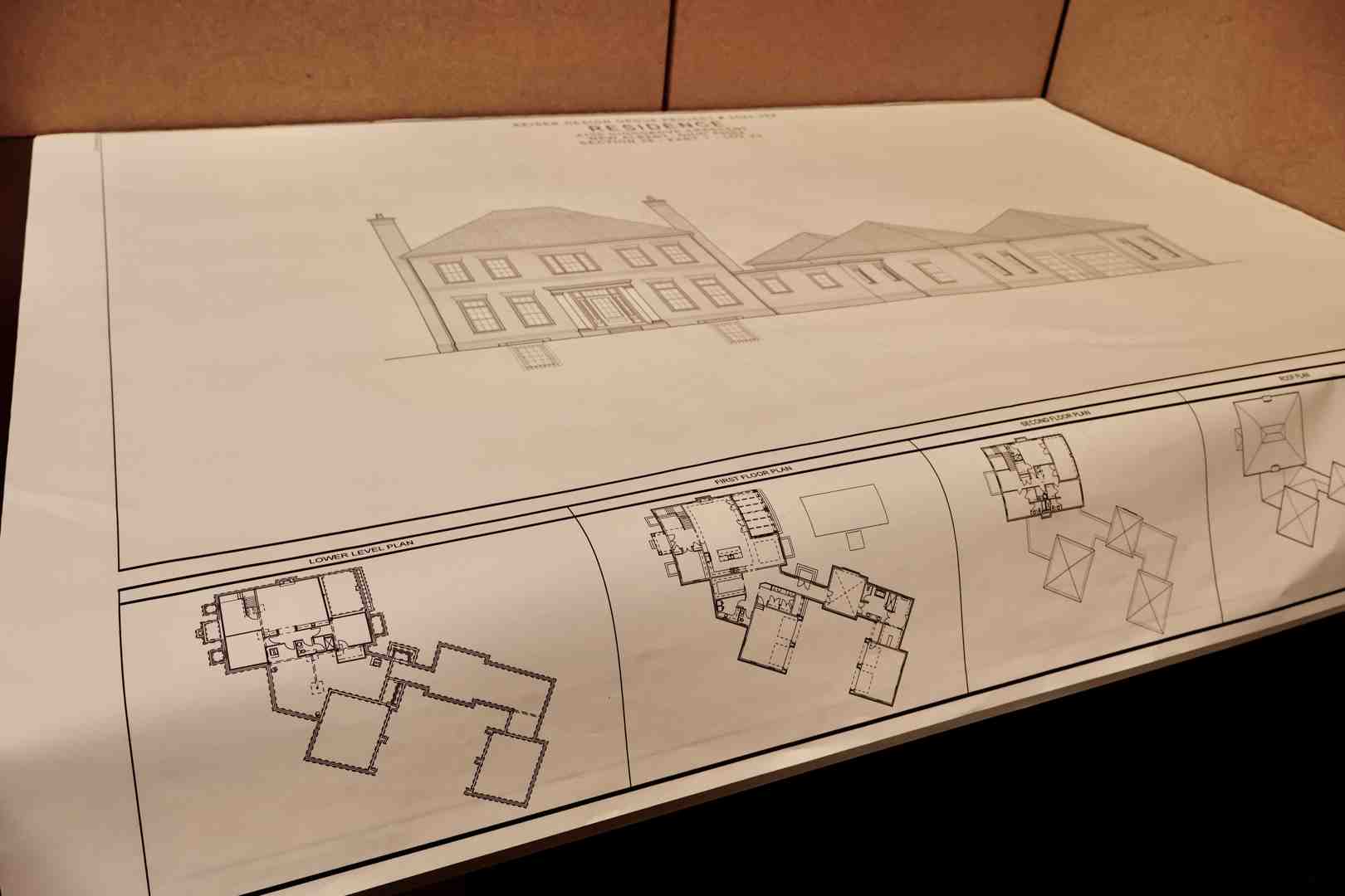 Architectural blueprints for a historic home addition displaying detailed elevations and structural plans