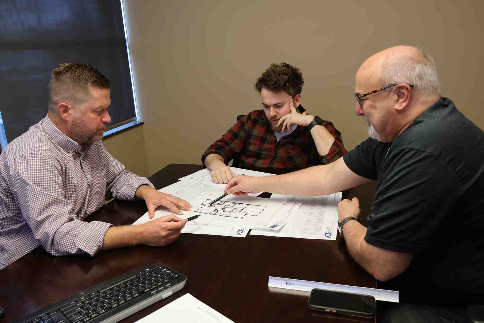 diverse project stakeholders collaborating over plans - Construction documentation services