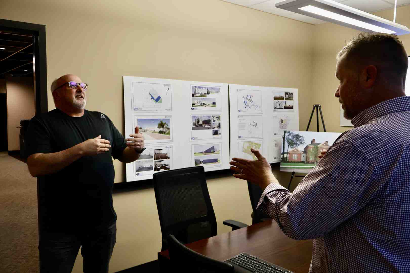 A diverse group of professionals collaborating on a commercial renovation project - renovating a commercial building