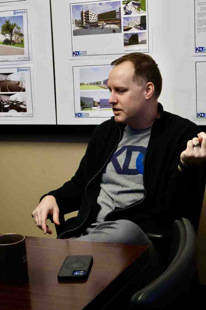 architect and clients collaborating over design plans - residential design services