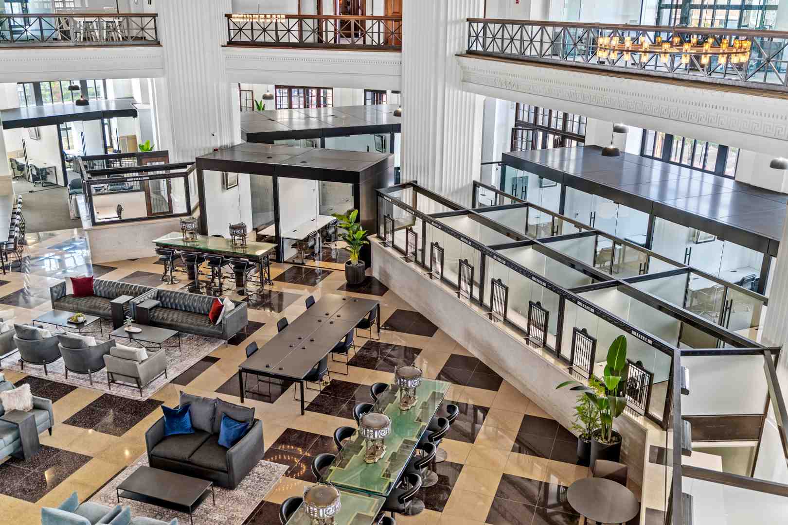 Modern resident lounge with floor-to-ceiling windows, contemporary furniture, and city views - Chicago theatre district apartments