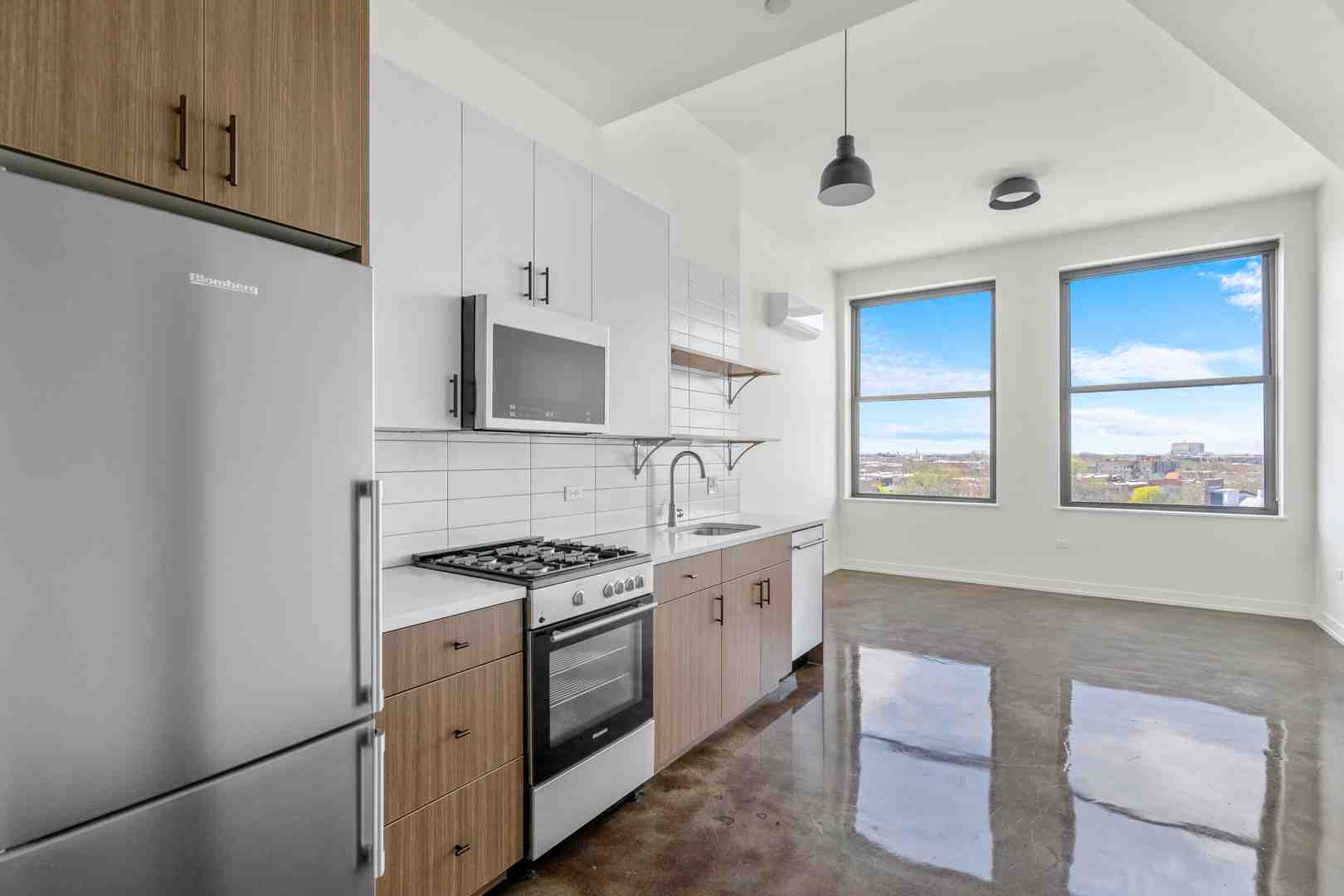 Modern loft kitchen with stainless steel appliances - Chicago loft apartments for rent