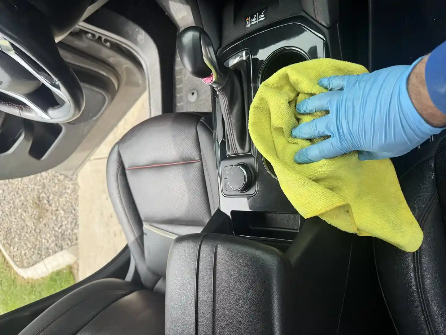 person carefully cleaning car dashboard - detail car at home