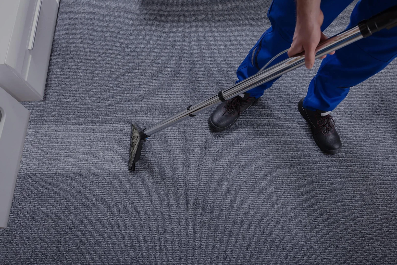 Professional uniform day porter providing facility maintenance in an Arlington Heights office lobby