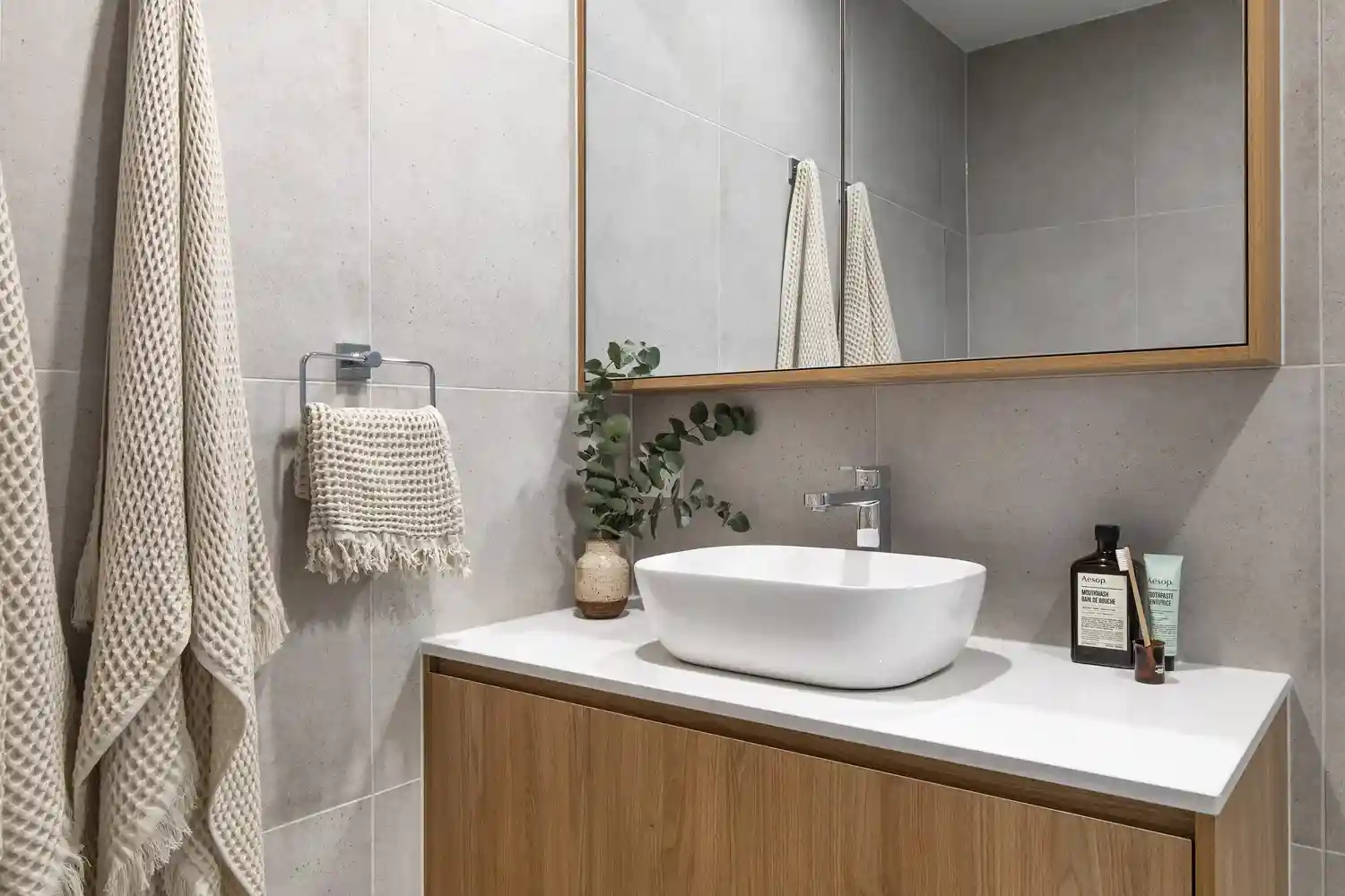 Close-up of high-quality, matte black tapware and sleek cabinet hardware on a bespoke floating vanity, highlighting the attention to detail and premium finishes used in G&M Craftsman Cabinets' projects. - small bathroom remodel