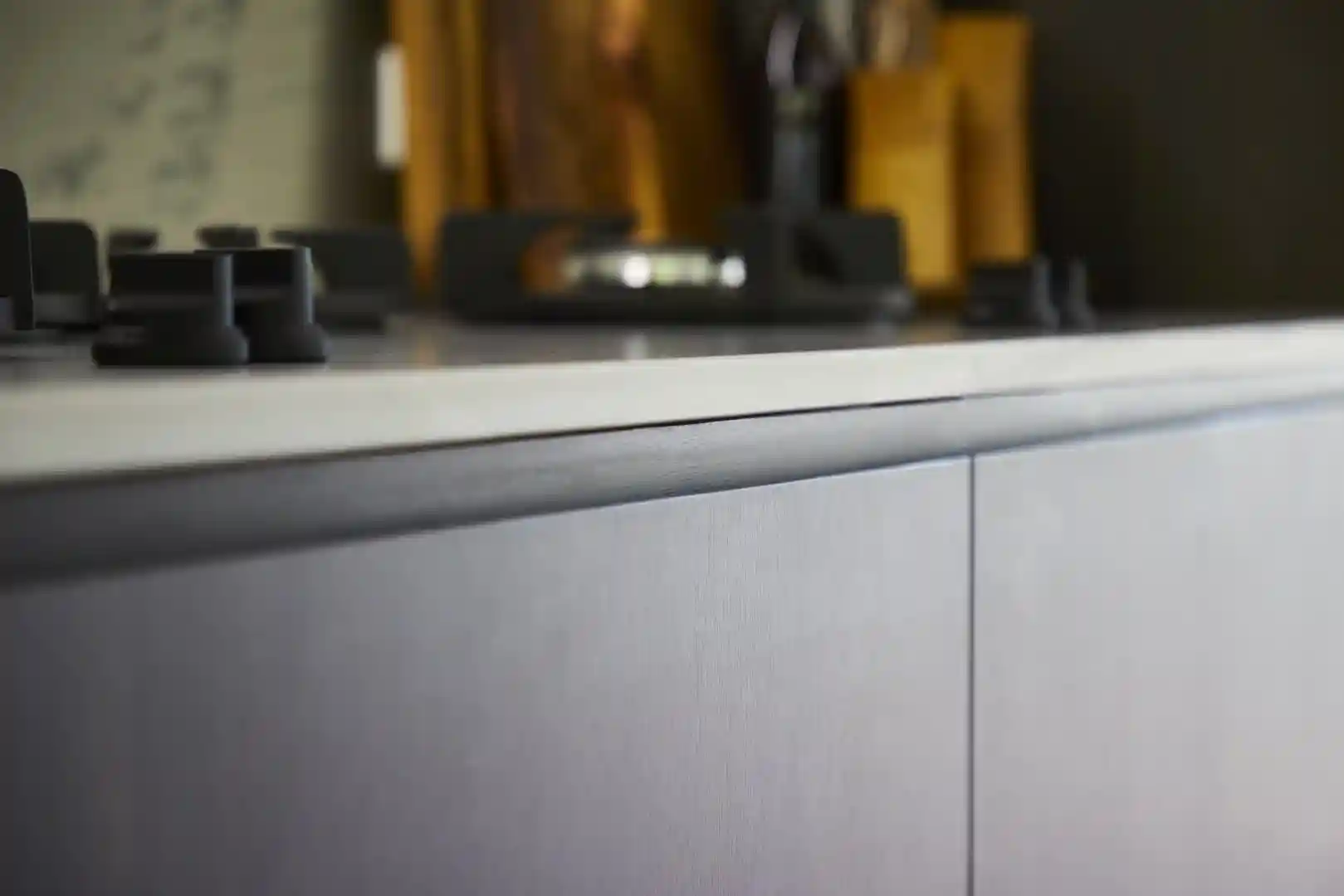 A carefully curated material palette showcases the harmony of timber, engineered quartz, and ceramic tile, forming the foundation for a bespoke kitchen design.