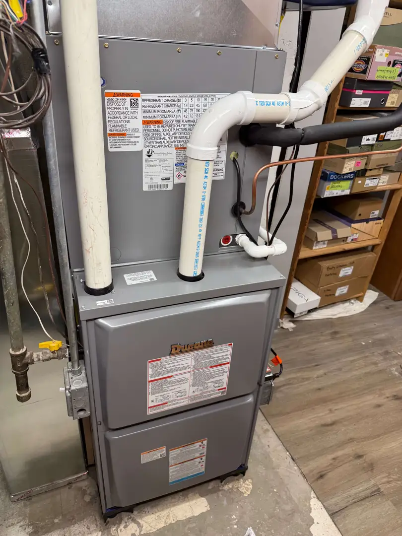 Licensed technician inspecting a residential furnace system in a Chicagoland home - emergency heating and cooling Licensed technician inspecting a residential furnace system in a Chicagoland home - emergency heating and cooling