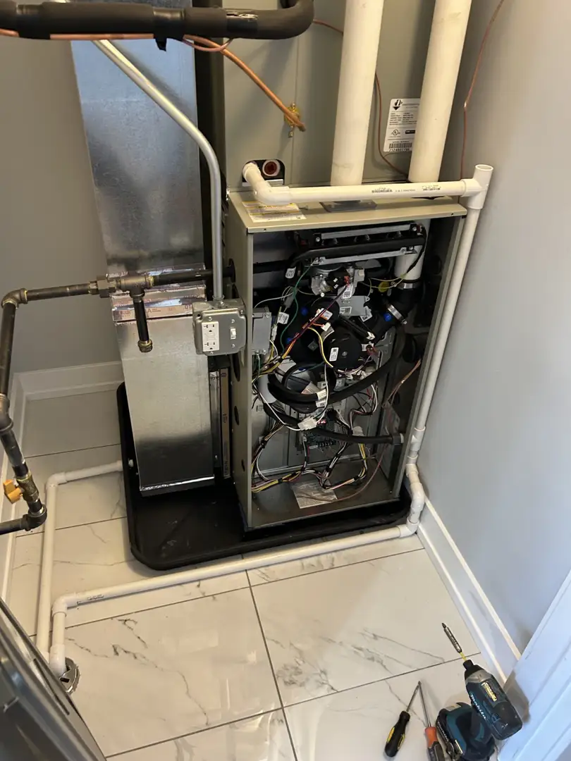 licensed HVAC technician inspecting furnace in Glenview home basement