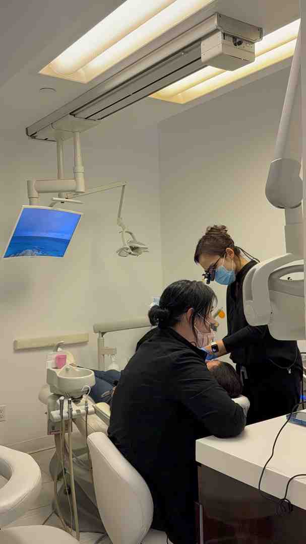 A dentist explaining a procedure to a patient in a modern NYC office - nys medicaid dental providers