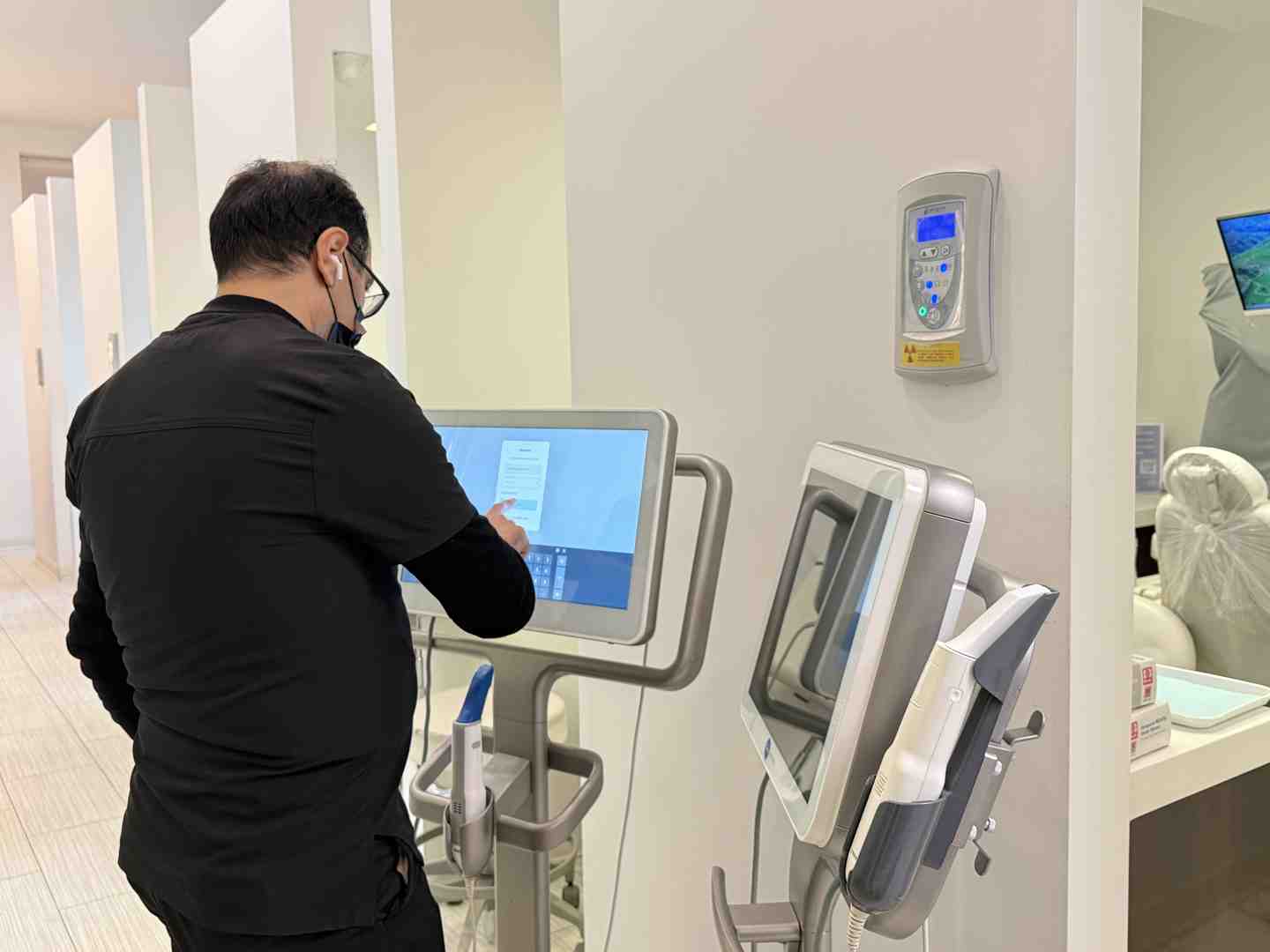 A close-up image of a dental professional using a curing light on a patient's composite filling - Composite filling cost
