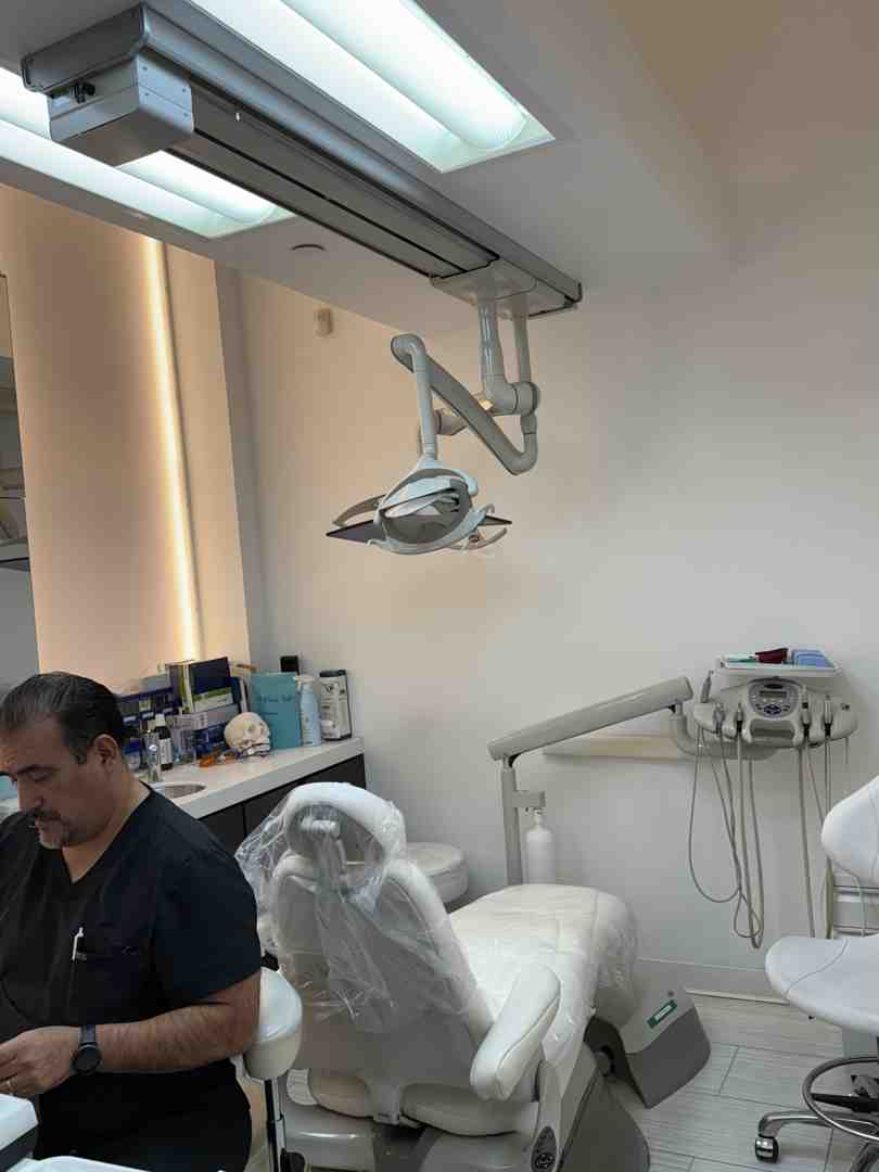dentist pointing to signs of wear on a dental model - grind teeth anxiety