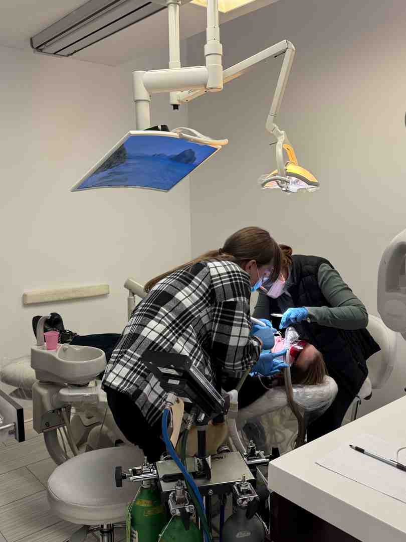 Dentist preparing a tooth for a filling in our comfortable Tribeca office