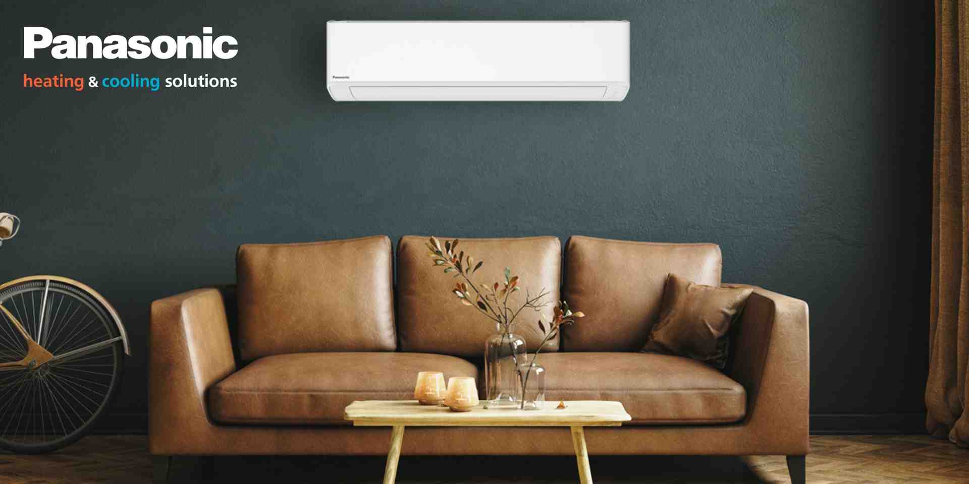 Technician using a tablet to assess a living room for a heat pump installation in an Auckland home - heat pump installation auckland