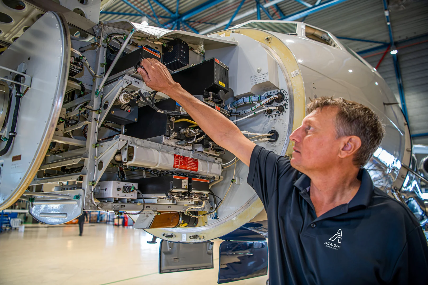 Aviation technicians performing a walk around on a Falcon 2000 pointing out service points