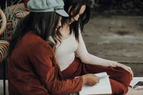 Collaborative therapy session with therapist and client looking at a workbook together - eating disorder behavioral therapy