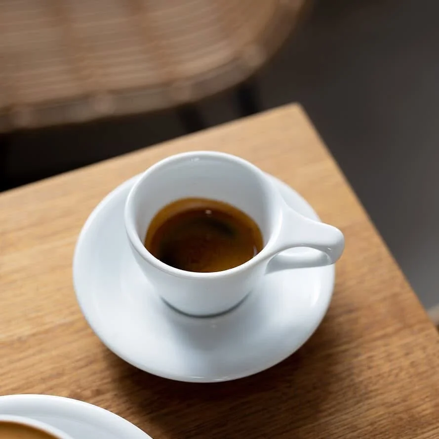 espresso shot and drip coffee sitting side by side on a table espresso shot and drip coffee sitting side by side on a table