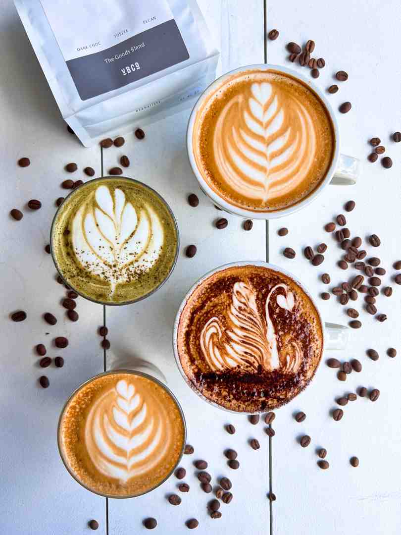 barista pouring latte art into a cup - best breakfast cafe