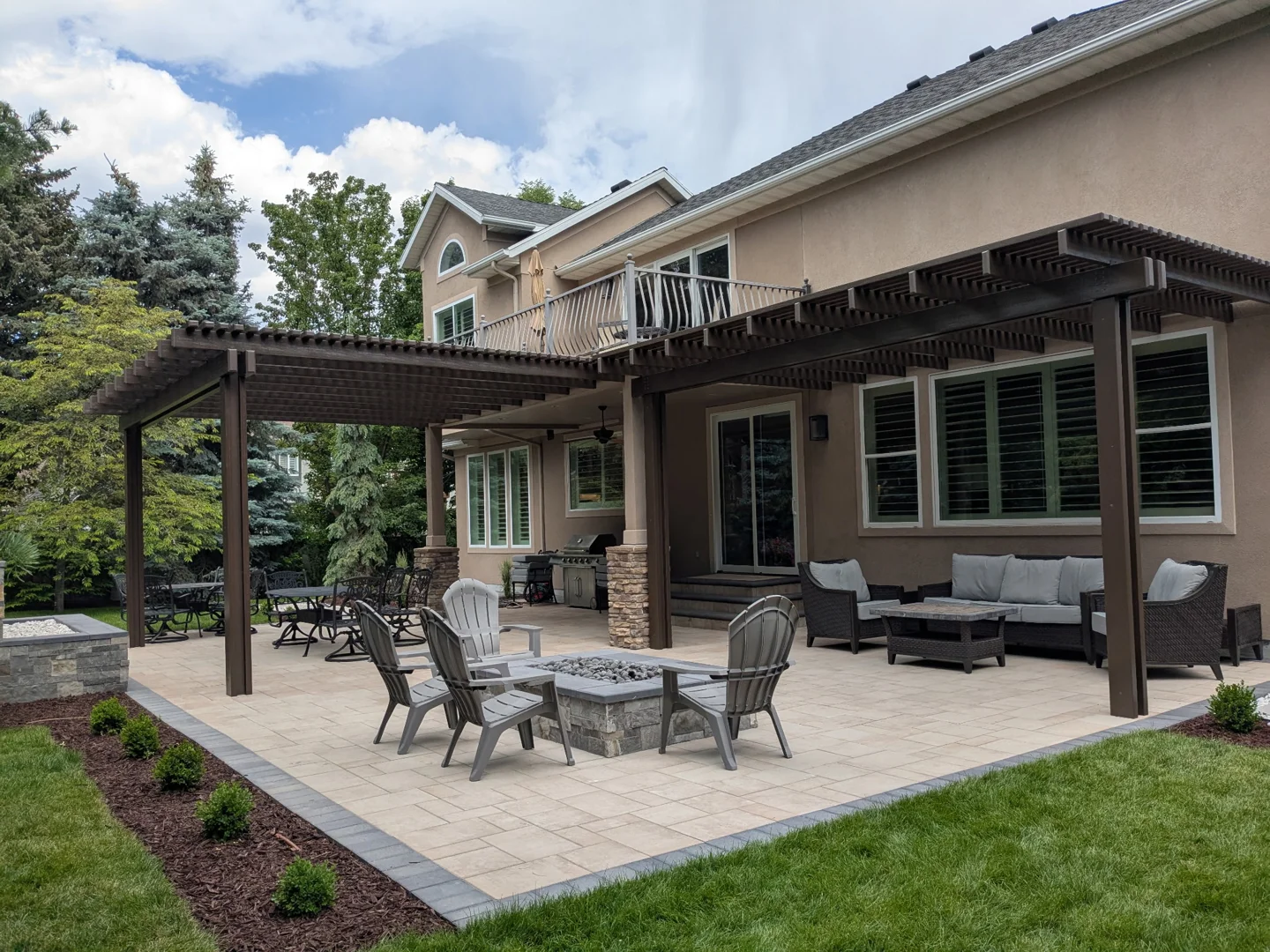 A 6m x 3m patio cover splitting space into a dining area on one side and a lounge area on the other A 6m x 3m patio cover splitting space into a dining area on one side and a lounge area on the other