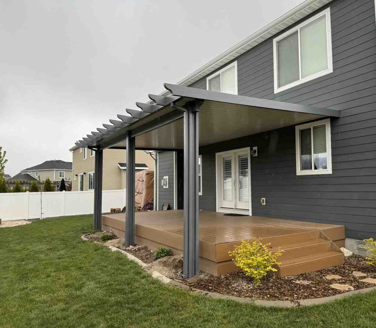 installers measuring and marking a wall for bracket placement - residential awning installation installers measuring and marking a wall for bracket placement - residential awning installation