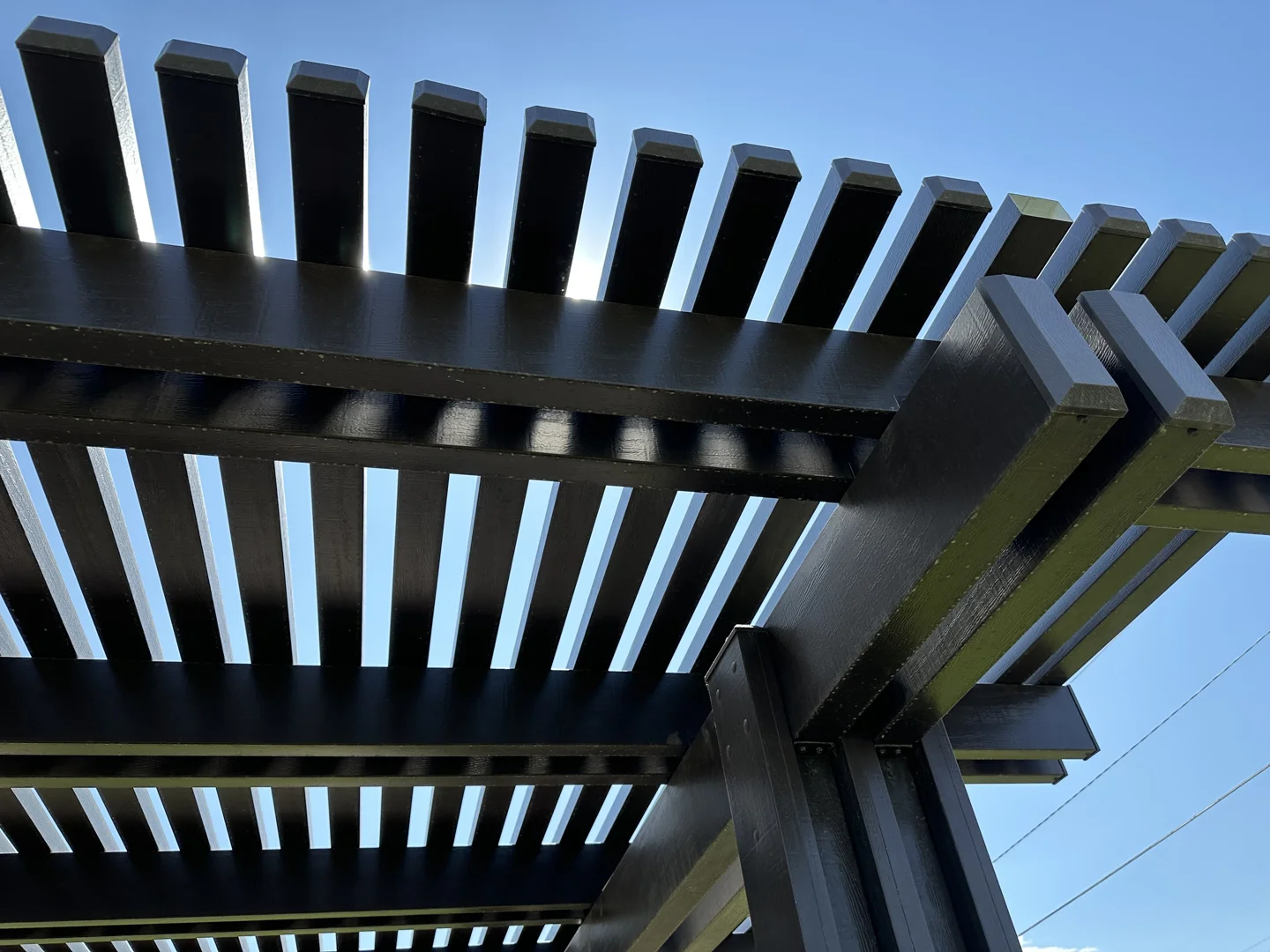Properly braced wood patio cover showing sturdy diagonal braces Properly braced wood patio cover showing sturdy diagonal braces