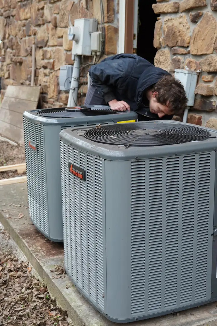 Technician measuring a Bartlesville home to determine the correct AC unit size and capacity - ac installation in