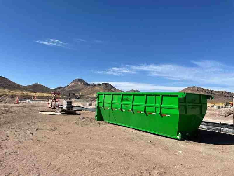 A roll-off dumpster at a residential construction site - Tucson waste removal A roll-off dumpster at a residential construction site - Tucson waste removal